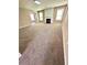 Open living room featuring plush carpeting, a cozy fireplace, and ample natural light at 4244 Old House Dr, Conley, GA 30288