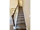 Carpeted staircase with white railing leading to the upper level of the home at 4244 Old House Dr, Conley, GA 30288