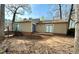 This home features a backyard with a small deck and lots of trees at 5050 Martins Crossing Rd, Stone Mountain, GA 30088