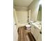 Bathroom with a bathtub, shower, toilet, vanity and wood-look tile flooring at 5050 Martins Crossing Rd, Stone Mountain, GA 30088