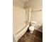 Bathroom with a bathtub, shower, toilet, and wood-look tile flooring at 5050 Martins Crossing Rd, Stone Mountain, GA 30088