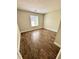 Bedroom featuring a window and wood-look tile flooring at 5050 Martins Crossing Rd, Stone Mountain, GA 30088