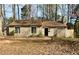 Charming single-story home featuring neutral siding and a well-maintained front yard at 5050 Martins Crossing Rd, Stone Mountain, GA 30088