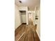Hallway with wood-look tile flooring, closets, and additional storage cabinets at 5050 Martins Crossing Rd, Stone Mountain, GA 30088