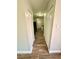 Hallway featuring wood-look tile flooring with storage and closet space at 5050 Martins Crossing Rd, Stone Mountain, GA 30088