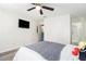 A well-lit bedroom shows wood-look floors, a ceiling fan, and an ensuite bathroom with a white shower stall at 813 Ridgefield Dr, Peachtree City, GA 30269