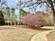 Community grounds featuring blooming trees, manicured lawns, and walking path at 813 Ridgefield Dr, Peachtree City, GA 30269