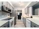 Well-lit kitchen with stainless steel appliances, gray cabinetry, and light countertops at 813 Ridgefield Dr, Peachtree City, GA 30269
