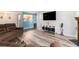 Spacious living room featuring wood floors, a TV, modern furniture, and access to the kitchen at 813 Ridgefield Dr, Peachtree City, GA 30269