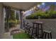 Inviting patio with outdoor seating, privacy lattice, and ambient lighting for a relaxing atmosphere at 813 Ridgefield Dr, Peachtree City, GA 30269