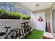 Charming patio space with a small table, artificial grass, and decorative accents for outdoor enjoyment at 813 Ridgefield Dr, Peachtree City, GA 30269