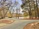 Scenic view of a pond surrounded by lush trees and a paved pathway in a serene community setting at 813 Ridgefield Dr, Peachtree City, GA 30269