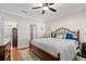 Bedroom with a wooden bed frame, hardwood floors, and large windows offering natural light at 2130 Birkdale St, Villa Rica, GA 30180