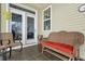 Relax on this covered porch with tiled floor, wicker furniture and outdoor seating at 2130 Birkdale St, Villa Rica, GA 30180