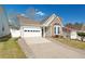 Beautiful home featuring a two-car garage, stone accents, and a well-maintained lawn at 2130 Birkdale St, Villa Rica, GA 30180