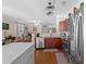 Open kitchen with stainless steel appliances, wooden cabinets, and an island flowing into the living area at 2130 Birkdale St, Villa Rica, GA 30180