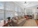 Inviting sunroom with many windows, neutral furniture and tile flooring at 2130 Birkdale St, Villa Rica, GA 30180