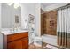 Bathroom featuring wood cabinets, a white toilet, and a shower with decorative tile surround at 326 Roswell Se St # 706, Marietta, GA 30060