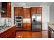 Modern kitchen with stainless steel appliances and rich wood cabinetry, and beautiful granite countertops at 326 Roswell Se St # 706, Marietta, GA 30060