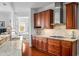 Open kitchen featuring granite countertops, stainless vent hood, and views of the bedroom at 326 Roswell Se St # 706, Marietta, GA 30060