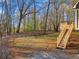 Backyard featuring a wooden staircase from deck, leading to the lawn at 9061 Greenwood Way, Canton, GA 30115