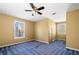 Bedroom with ceiling fan, neutral walls, and blue carpet at 9061 Greenwood Way, Canton, GA 30115
