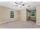Neutral carpeted bedroom with two windows and a ceiling fan at 9061 Greenwood Way, Canton, GA 30115