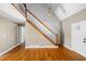 Bright foyer with hardwood floors, white staircase, and natural light at 9061 Greenwood Way, Canton, GA 30115