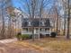 Charming home with a welcoming front porch, set amongst beautiful trees at 9061 Greenwood Way, Canton, GA 30115