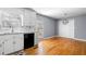 Eat-in kitchen with white cabinets, granite countertops, and stainless steel dishwasher at 9061 Greenwood Way, Canton, GA 30115