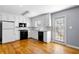 Charming kitchen with white cabinets, granite countertops, and modern black appliances, offering style and function at 9061 Greenwood Way, Canton, GA 30115
