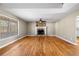 Spacious living room featuring hardwood floors, a stone fireplace, and a large window offering ample light at 9061 Greenwood Way, Canton, GA 30115