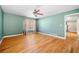 Spacious living room with hardwood floors, ceiling fan, and natural light at 9061 Greenwood Way, Canton, GA 30115