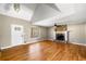 Cozy living room with stone fireplace, hardwood floors, and a bright window for natural light at 9061 Greenwood Way, Canton, GA 30115