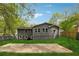 Large backyard with fresh grass, patio, privacy fence, and mature shade trees at 2115 Randolph Nw Cir, Kennesaw, GA 30144