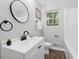 Bright bathroom featuring a modern vanity, round mirror, and shower at 2115 Randolph Nw Cir, Kennesaw, GA 30144