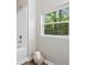 Bright bathroom featuring a tub, shower, and a window with serene outdoor views at 2115 Randolph Nw Cir, Kennesaw, GA 30144