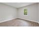 Bright bedroom with hardwood floors and a window overlooking the yard at 2115 Randolph Nw Cir, Kennesaw, GA 30144