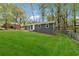 Well-maintained home featuring a lush green lawn, gray painted brick, and mature trees in the background at 2115 Randolph Nw Cir, Kennesaw, GA 30144