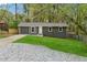 Charming single-story home with a gray exterior, fresh green lawn, and a gravel driveway at 2115 Randolph Nw Cir, Kennesaw, GA 30144