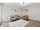 Inviting living room with wood-look floors, gray sofa, and neutral walls for a modern aesthetic at 2115 Randolph Nw Cir, Kennesaw, GA 30144