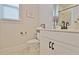 Clean bathroom features a modern vanity, toilet, mirror, and plenty of natural light at 516 Cunninghame Ct, Peachtree City, GA 30269