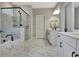 Bathroom features a luxurious soaking tub, a glass shower with marble-style tiles, and double sinks at 516 Cunninghame Ct, Peachtree City, GA 30269