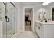 Bathroom features a glass shower, tile floors, and entrance to walk-in closet at 516 Cunninghame Ct, Peachtree City, GA 30269