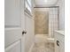 Bathroom featuring shower and tub with tiled surround, toilet, and a vanity sink at 516 Cunninghame Ct, Peachtree City, GA 30269