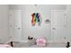 Bright bedroom with two doors, unicorn chair, and colorful hair bow decorations at 516 Cunninghame Ct, Peachtree City, GA 30269