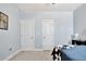 Bright bedroom featuring a picture of Atlanta and doors to two closets at 516 Cunninghame Ct, Peachtree City, GA 30269