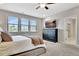 Bedroom featuring a dresser, TV, natural light, and an ensuite bathroom entrance with tiled floors at 516 Cunninghame Ct, Peachtree City, GA 30269