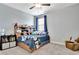 Bedroom with a comfortable bed, a ceiling fan, and a cozy chair beside the bed at 516 Cunninghame Ct, Peachtree City, GA 30269