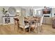 Open-concept dining room with modern decor and hardwood floors, flowing into the living area at 516 Cunninghame Ct, Peachtree City, GA 30269